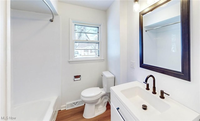 bathroom featuring toilet, wood-type flooring, and vanity