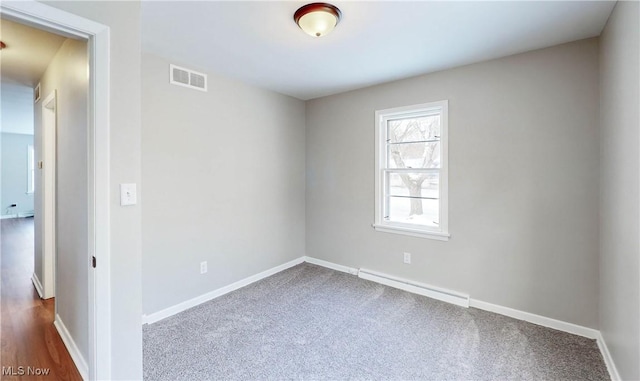 unfurnished room with carpet and a baseboard radiator