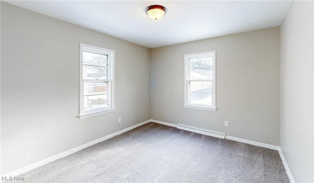 carpeted empty room featuring a baseboard radiator