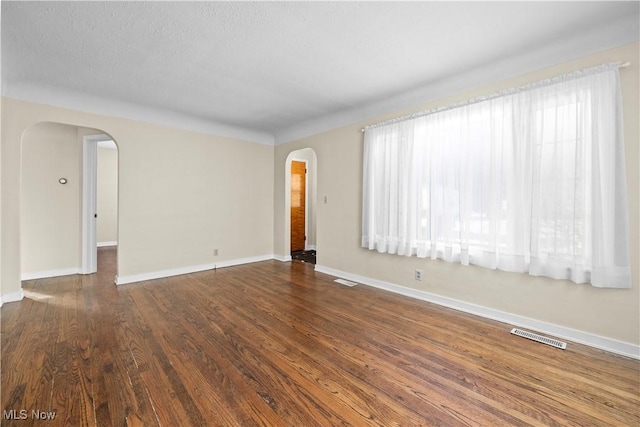 spare room with dark hardwood / wood-style flooring