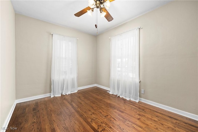 empty room featuring ceiling fan and dark hardwood / wood-style floors