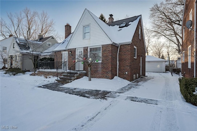 view of front of property featuring a garage and an outdoor structure