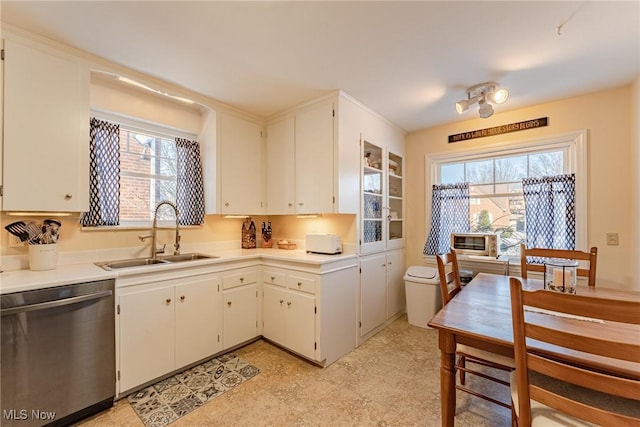 kitchen with sink, white cabinetry, dishwasher, and plenty of natural light