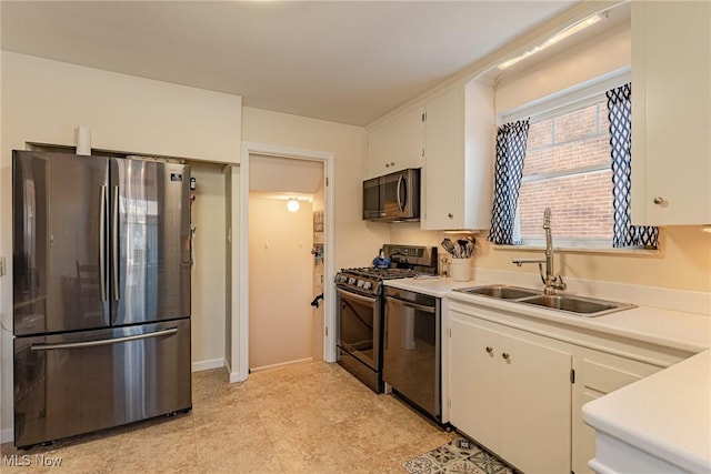 kitchen with sink, white cabinetry, and stainless steel appliances