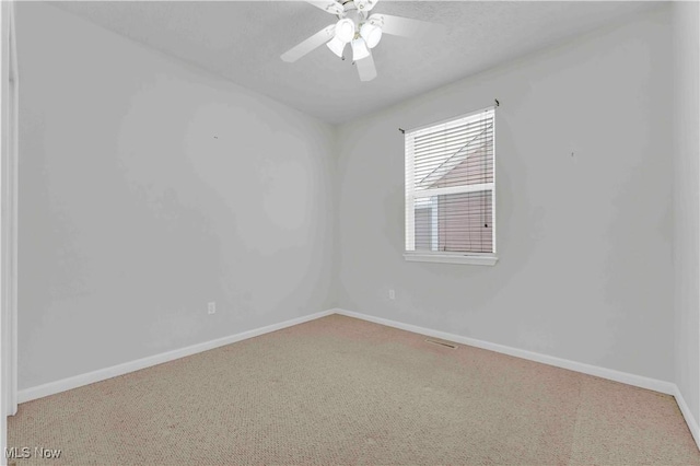 spare room featuring ceiling fan, carpet, and a textured ceiling