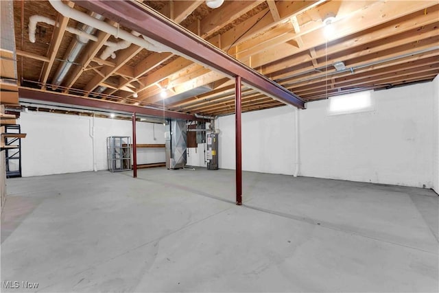 basement featuring heating unit and water heater