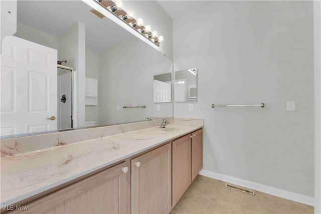 bathroom featuring toilet, walk in shower, and vanity