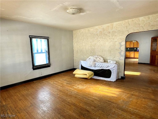 bedroom with dark hardwood / wood-style flooring