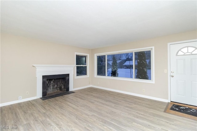 unfurnished living room featuring light wood-type flooring