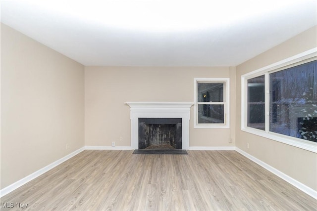 unfurnished living room featuring light wood-type flooring