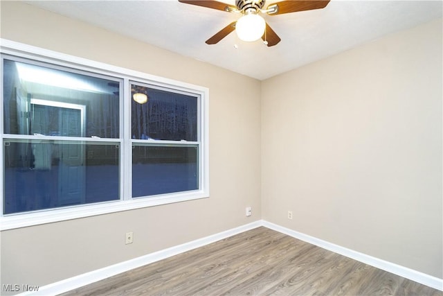 spare room featuring ceiling fan and hardwood / wood-style flooring