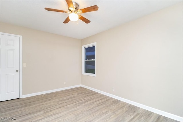 empty room with ceiling fan and light hardwood / wood-style floors