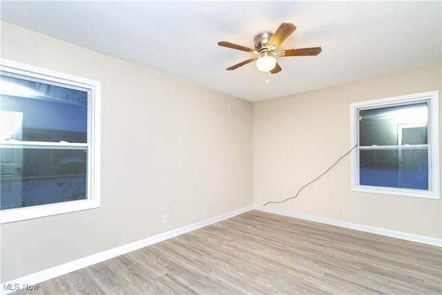 spare room featuring light hardwood / wood-style floors and ceiling fan