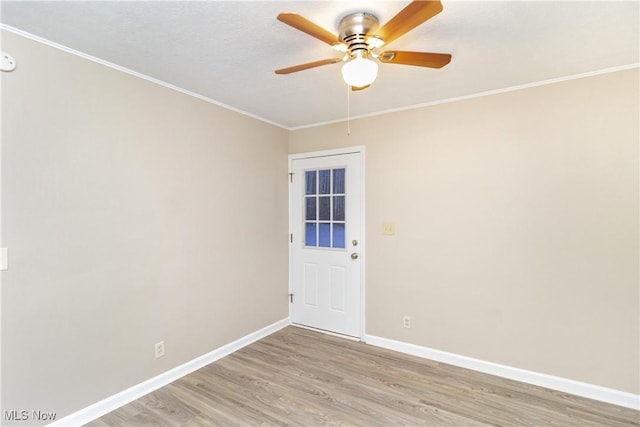 unfurnished room featuring ceiling fan, light hardwood / wood-style flooring, and crown molding