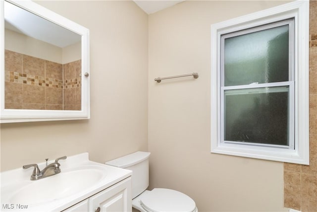 bathroom featuring toilet and vanity