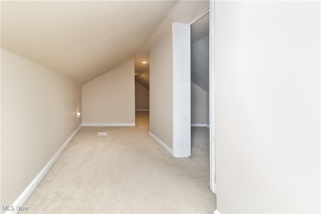 bonus room featuring light carpet and vaulted ceiling