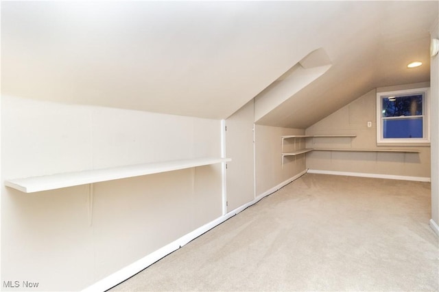 bonus room featuring lofted ceiling and light carpet