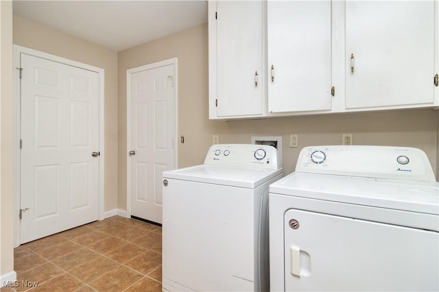 washroom with washer and dryer and cabinets