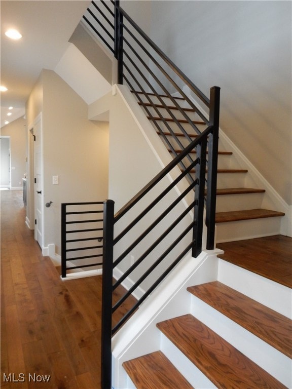 staircase featuring wood-type flooring