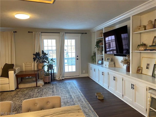 interior space featuring dark wood-type flooring and ornamental molding