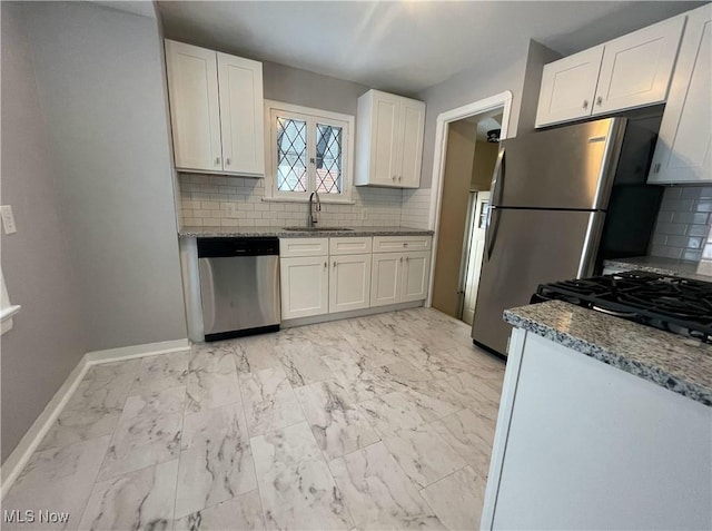 kitchen with white cabinets, appliances with stainless steel finishes, and sink