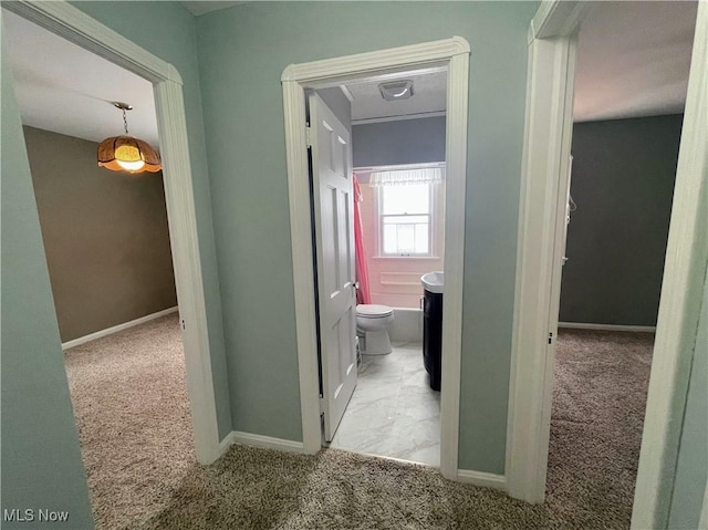 hallway featuring light carpet