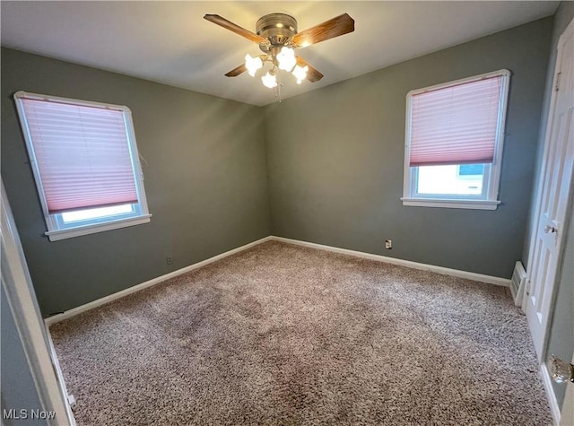 carpeted empty room featuring ceiling fan