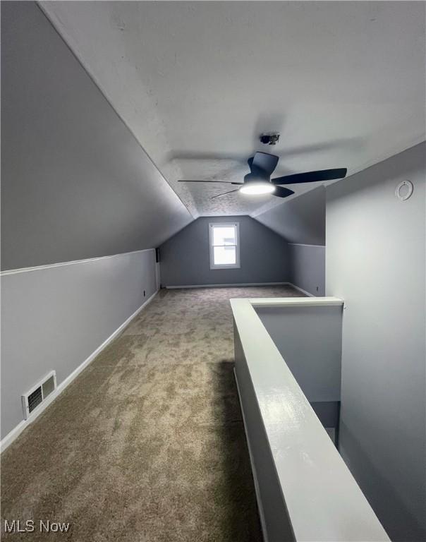 bonus room featuring ceiling fan, carpet, and lofted ceiling