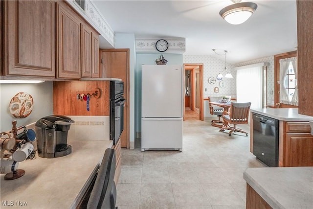 kitchen with a chandelier, hanging light fixtures, and black appliances