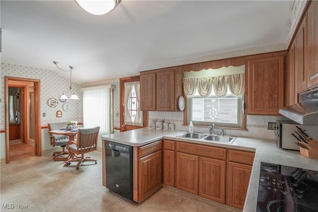 kitchen featuring decorative light fixtures, sink, a wealth of natural light, and black dishwasher