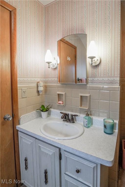 bathroom featuring tile walls and vanity