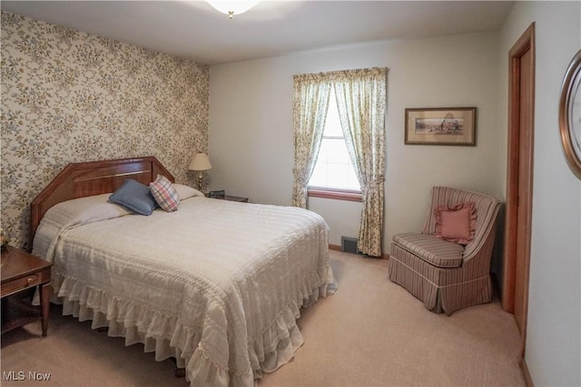 bedroom featuring light carpet