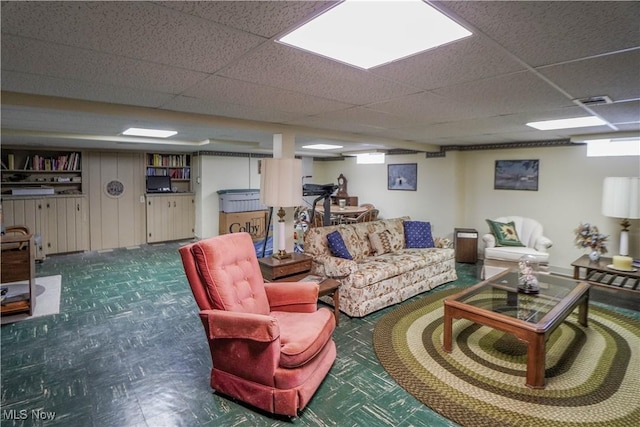 living room featuring a drop ceiling