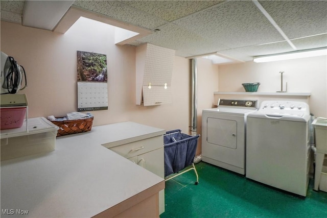 washroom with cabinets and washing machine and dryer