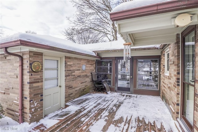 view of snow covered property entrance