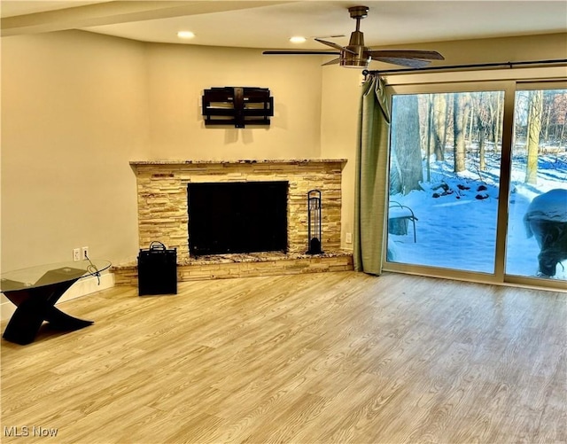 living room featuring ceiling fan, a fireplace, wood finished floors, and recessed lighting