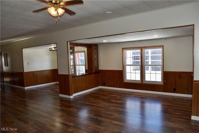 spare room with ceiling fan and dark hardwood / wood-style floors