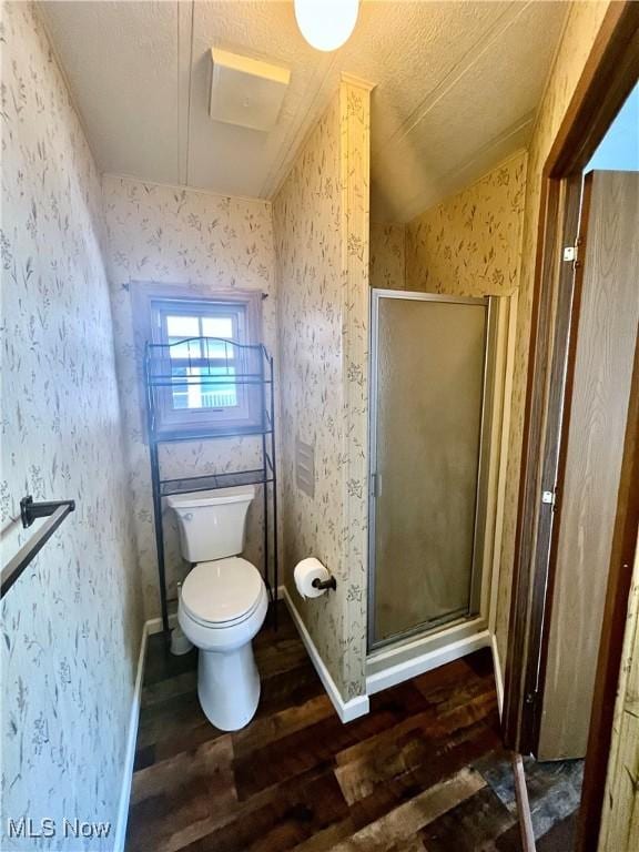 bathroom featuring an enclosed shower, vaulted ceiling, toilet, and hardwood / wood-style floors