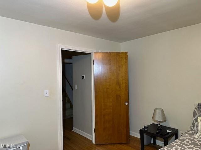 bedroom with ceiling fan and wood-type flooring