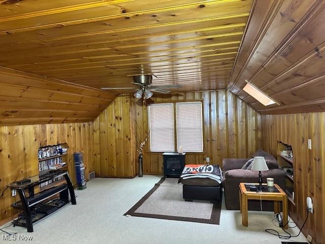 living area with lofted ceiling, wood ceiling, and carpet flooring