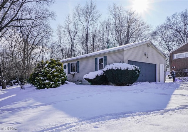 view of snowy exterior with a garage