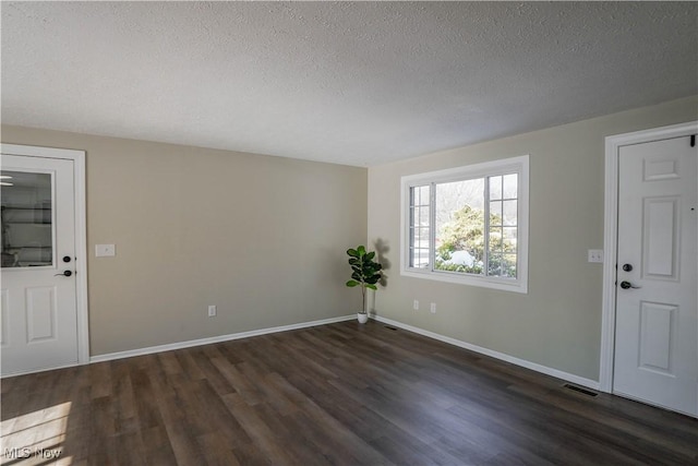 foyer featuring a textured ceiling and dark hardwood / wood-style floors