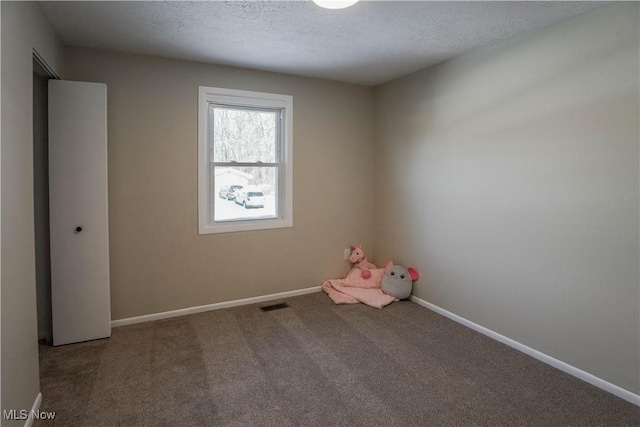 playroom with carpet and a textured ceiling