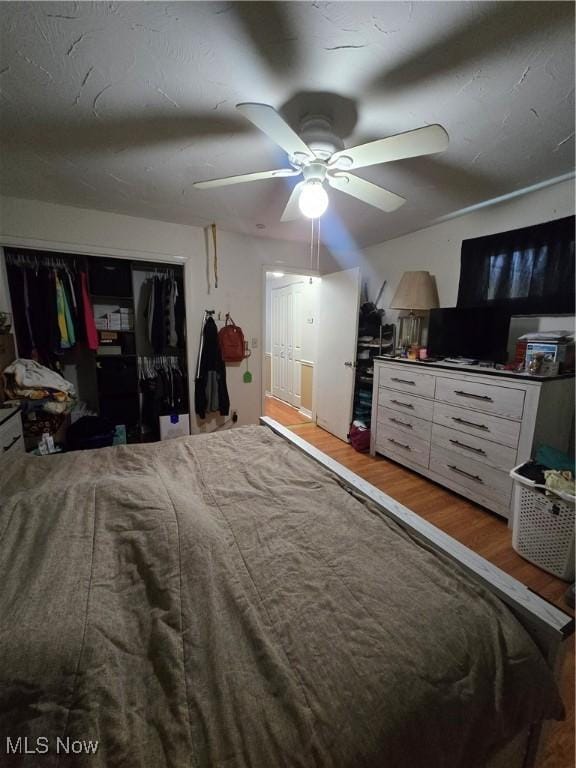 bedroom featuring a closet, hardwood / wood-style floors, and ceiling fan