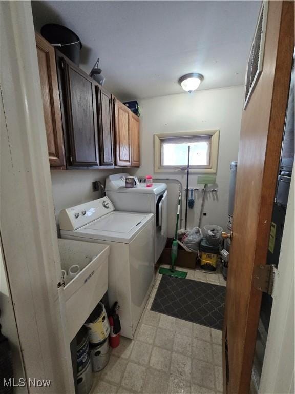 clothes washing area with independent washer and dryer and cabinets