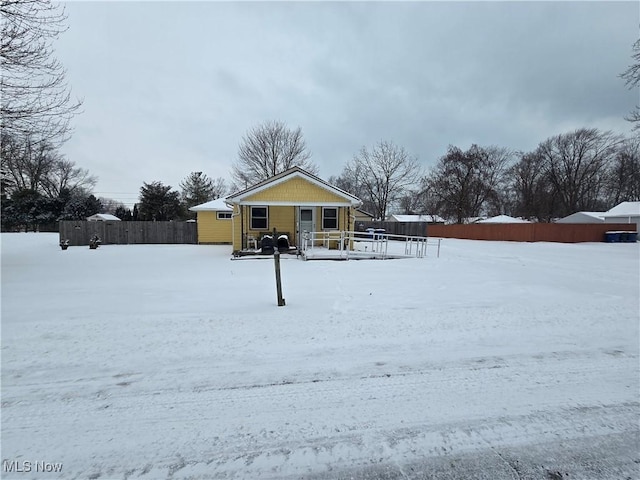 snow covered house with covered porch