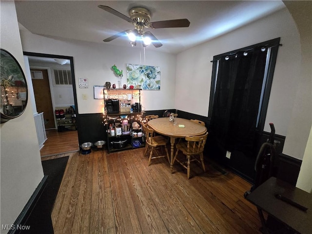 dining space with ceiling fan and hardwood / wood-style floors