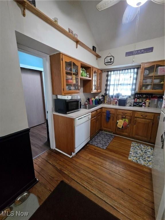 kitchen with ceiling fan, dark hardwood / wood-style floors, dishwasher, and high vaulted ceiling