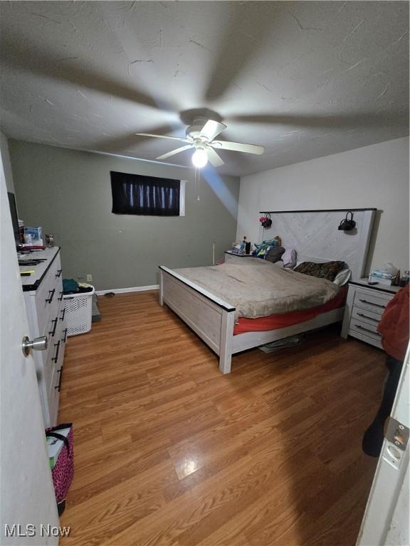 bedroom featuring light wood-type flooring and ceiling fan