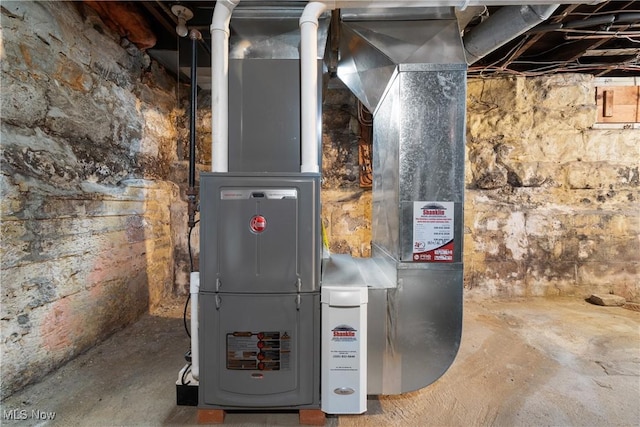 utility room featuring heating unit